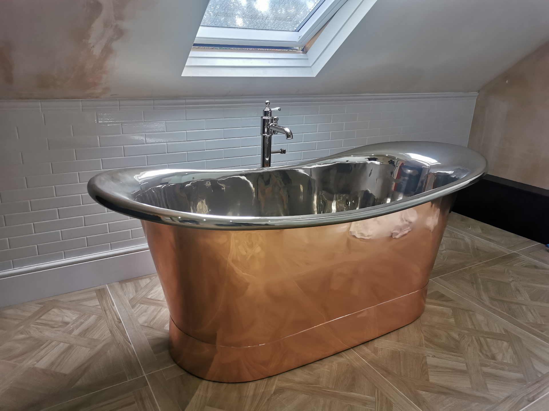 Copper freestanding bath in loft conversion