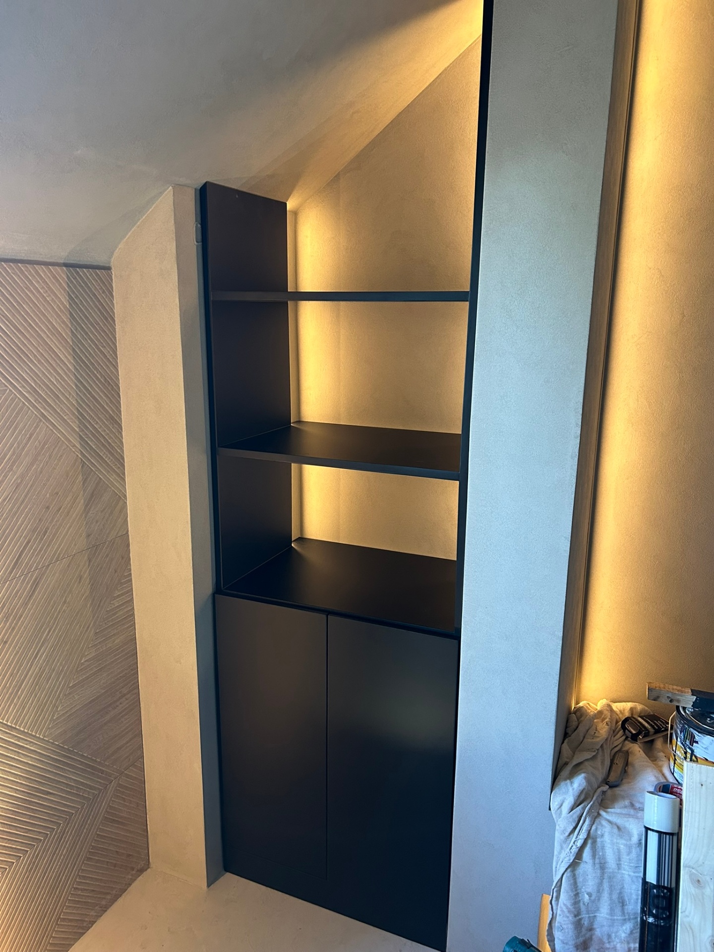 Black built-in shelving unit with LED backlighting