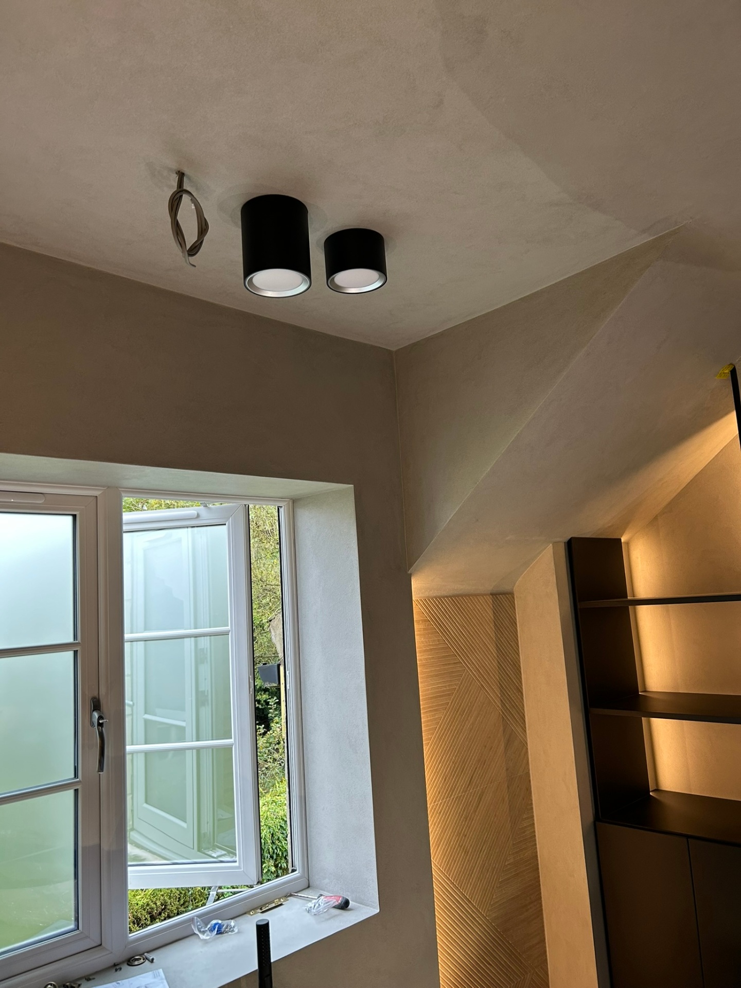 Microcement walls and ceiling with modern spot lighting