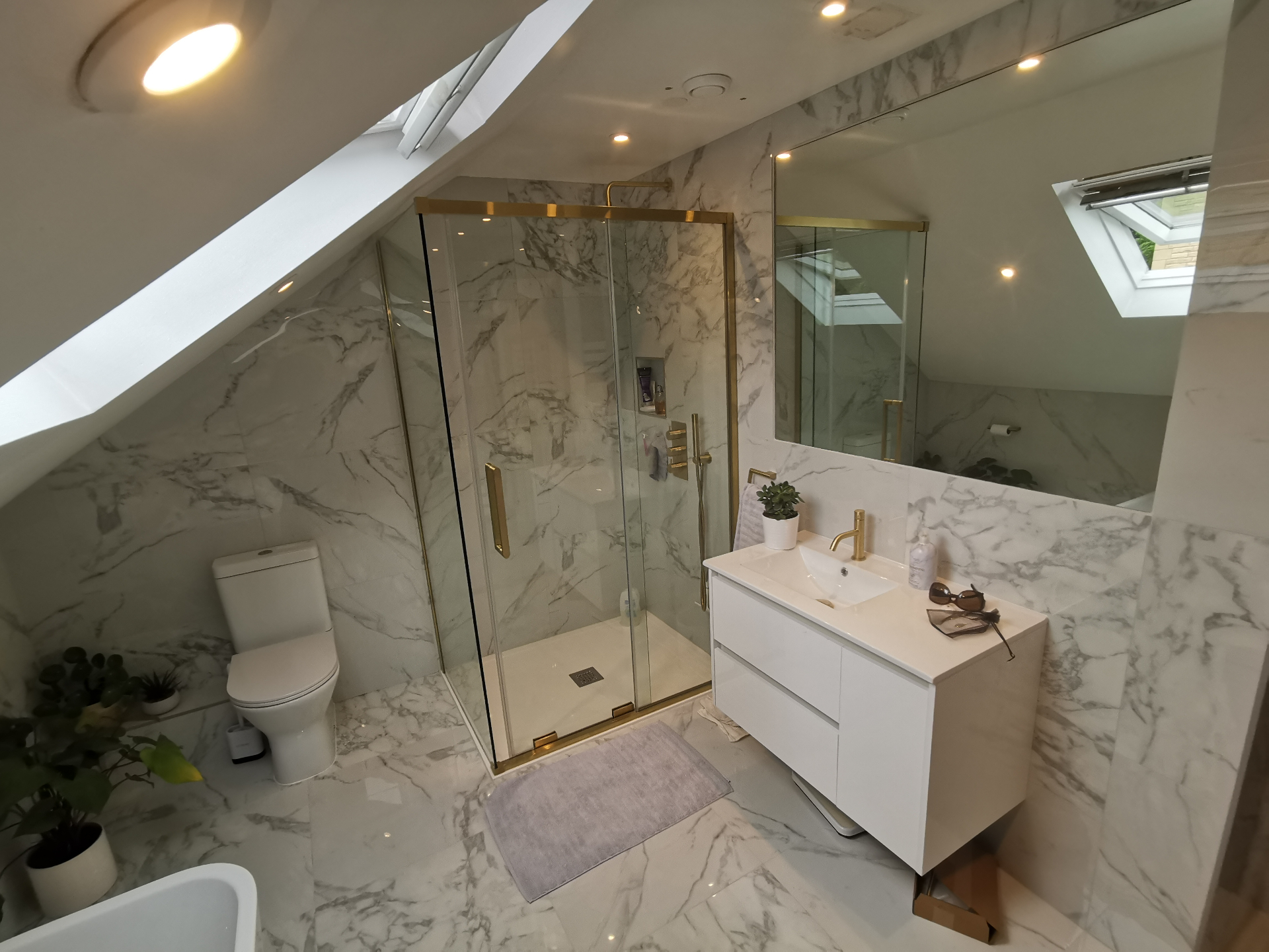 Marble bathroom vanity with mirror and brass tap