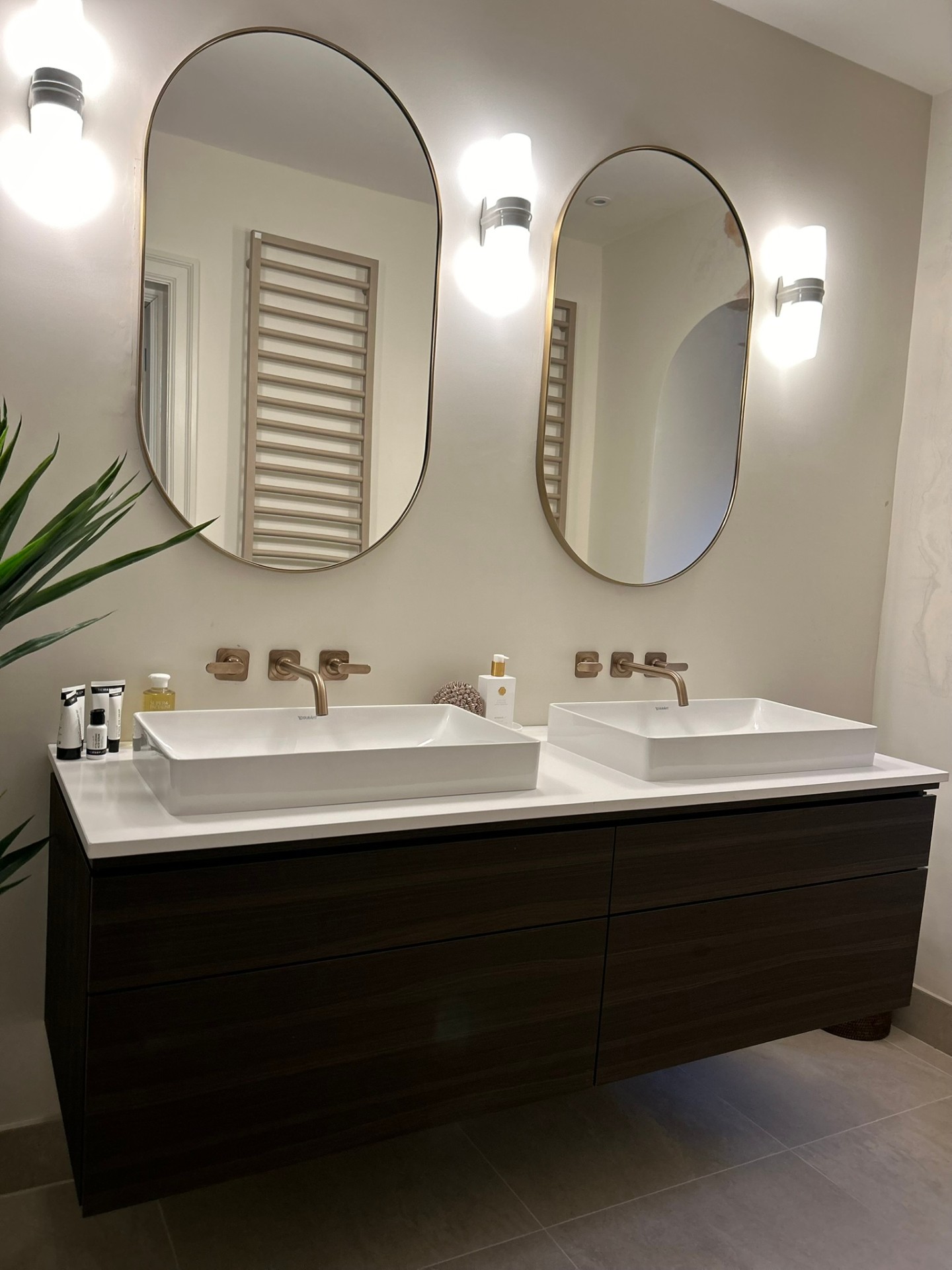 Close-up of twin basin vanity with bronze taps
